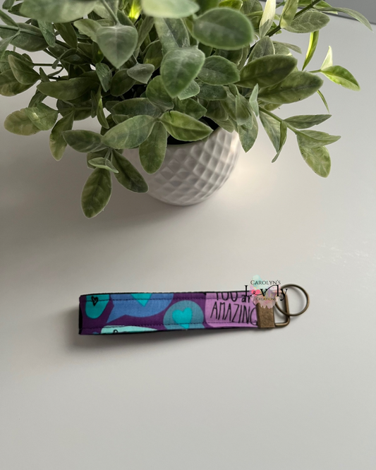 Purple Fabric Wristlet Keychain with Colorful Hearts and Inspirational Phrases – Handmade and Unique
